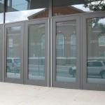 I wonder if the aluminum hinges are a design element.  Bronze would have been less visible.