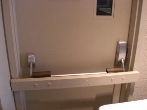 Very creative means of securing a panic bar.